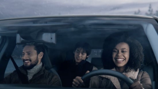 Three passengers riding in a vehicle and smiling | Bridgewater Nissan in Bridgewater NJ