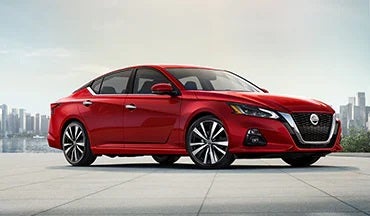 2023 Nissan Altima in red with city in background illustrating last year's 2022 model in Bridgewater Nissan in Bridgewater NJ